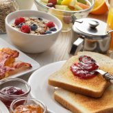 Hearty breakfast spread with toast, jam, scrambled eggs, bacon, fruit and coffee—perfect start before a tropical brunch at The Sugar Cane in Clapham.