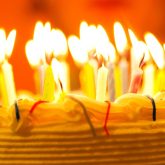Close-up of a birthday cake with lit candles, symbolising birthday celebrations at an affordable party venue in London.