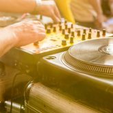 DJ playing music at a summer party in The Sugar Cane tiki bar, Clapham Junction London